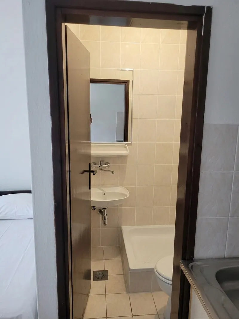 Private tiled bathroom with basin, mirror, shower tray and WC